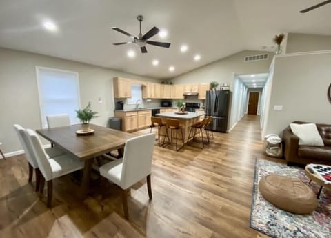 Open concept kitchen, dining & living room space