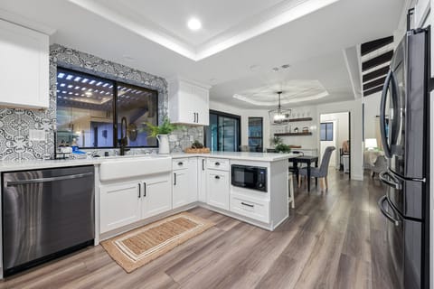The kitchen in the main house has all new appliances and a farmhouse sink.