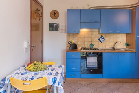 Family Apartment, 1 Bedroom (Casa Emozione With Shared Pool) | Private kitchen | Oven, stovetop, cookware/dishes/utensils, dining tables