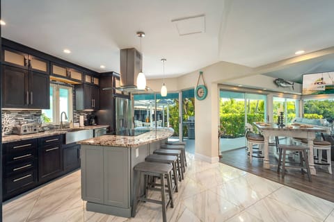 Lush tropical landscaping envelops this exquisite property.