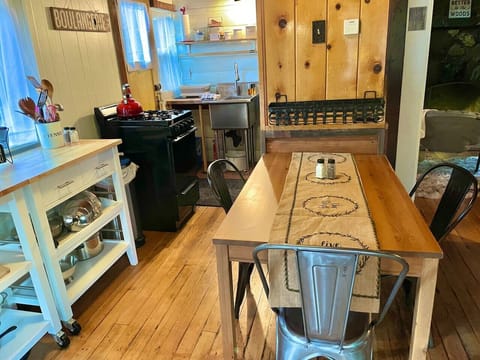 There is a roomba (robot vacuum) under the kitchen counters. Push the power button when you head out and come back to clean floors (a personal favorite!). The robot will “eat” or get caught on cords left on the floor.