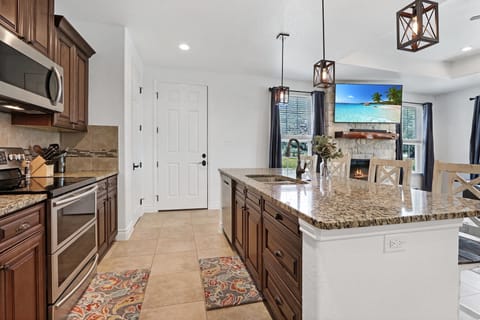 View of the kitchen island looking at the living room television.