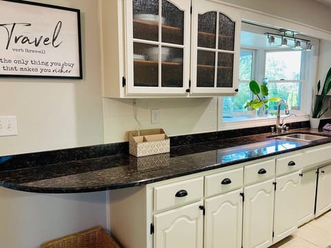 Gorgeous garden window above the sink looks out onto the balcony and back yard.