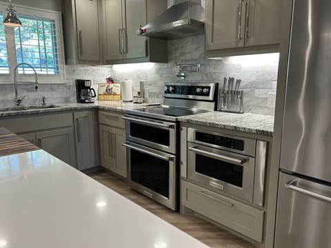 Kitchen has a double oven and wall mount microwave for lots of cooking options. 