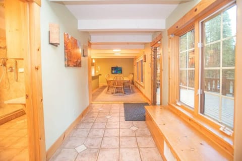 The view down the light-filled hallway that connects the living room to the kitchen and dining area.