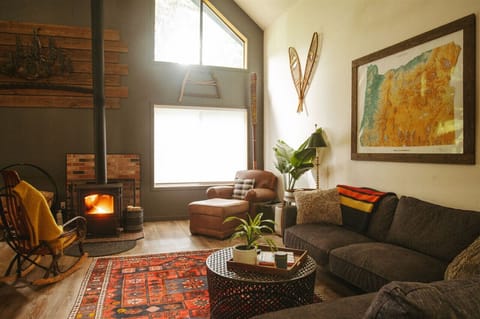 Living Room: Large sectional, oversized leather chair and rocking chair by the wood burning stove.