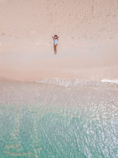 On the beach, white sand, sun loungers, beach towels