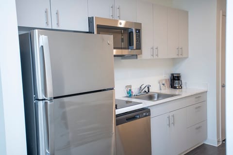 Basic Studio Suite, 1 King Bed | Private kitchenette | Full-size fridge, microwave, stovetop, dishwasher
