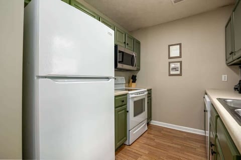 Cook up a storm in this vibrant, fully-equipped space with cheerful green accents!