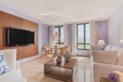 Grand Suite | Living area | 55-inch TV with satellite channels, iPad, Netflix