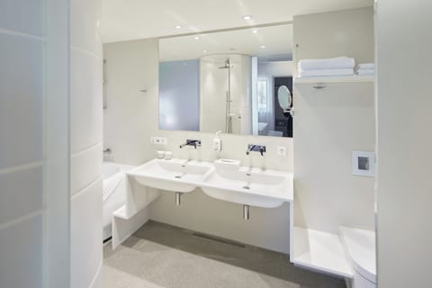 Suite, 1 King Bed (Additional Living Area) | Bathroom | Rainfall showerhead, free toiletries, hair dryer, heated floors