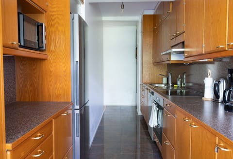 Comfort Apartment | Private kitchen | Full-size fridge, microwave, oven, stovetop