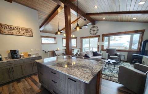 A large island in the kitchen helps to prepare food. 