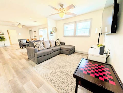 A chess table and large couch for play and entertainment.