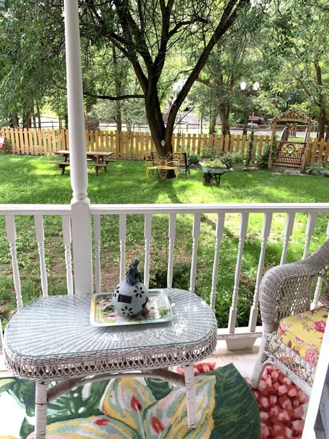 The lovely back porch with views to the bridge and antique lightpost. 