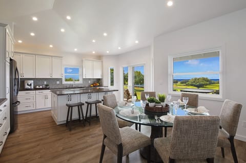 Open dining and living area offering a seamless flow for family gatherings and relaxation, complemented by stunning views.