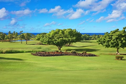 The lanai offers a scenic view of the golf course, blending lush greenery with a peaceful atmosphere.