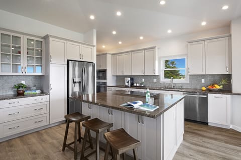 Modern kitchen with sleek appliances and a functional layout, perfect for preparing meals with ease.