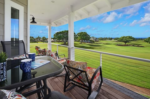 Lanai view overlooking vibrant greenery, perfect for enjoying a morning coffee or an evening glass of wine.
