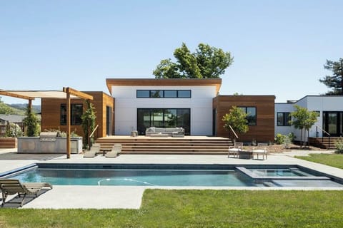 The spacious grounds feature comfortable seating around the pool and on the oversized deck overlooking vineyards.