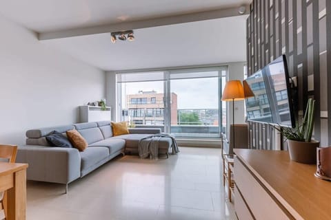 Bright living area with large windows and an open coastal atmosphere.
