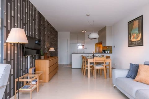 Stylish living and dining room with calm textures and natural flow.