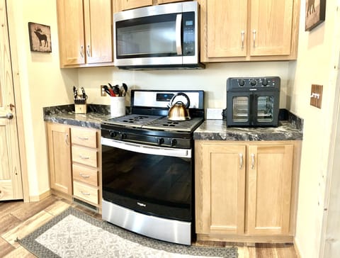 The kitchen is well-stocked with appliances, tools and basic ingredients. 