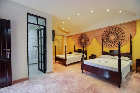 Deluxe Quadruple Room | Minibar, individually decorated, individually furnished, bed sheets