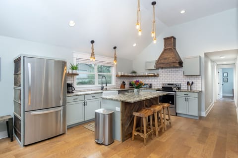 Kitchen complete with island with seating for 3, a dishwasher & a standard Drip coffeemaker.
