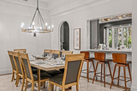 The dining room and kitchen flow together, the bar stool area which seats three and the dining room table seats ten.