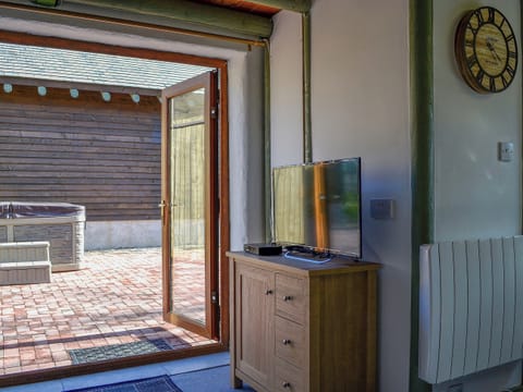 Double doors opening onto a spacious and welcoming interior | Lucy’s Lodge - Doddick Farm Cottages, Threlkeld, near Keswick