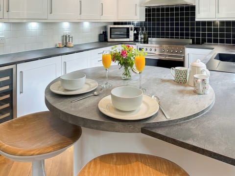 Remodelled kitchen showing its breakfast bar, bottle fridge and smeg induction range | Tigh-na-Creige, Colintraive