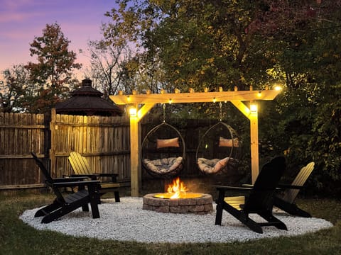 Custom fire pit with hanging chairs and new Adirondack chairs