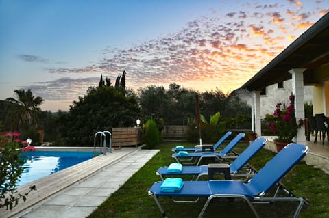 Pool and sun loungers at night