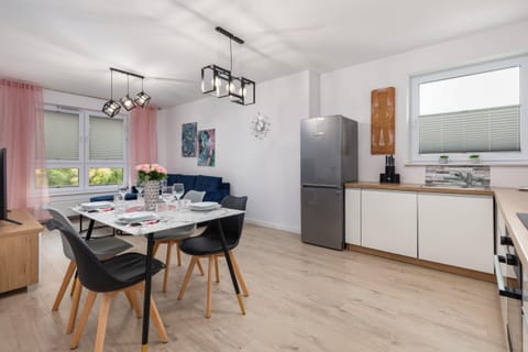 A wide view of the dining and kitchen area, emphasizing its spacious and modern design.