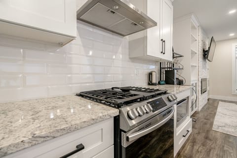 Cooking Area with plenty of counter space, gas stove and oven, microwave.