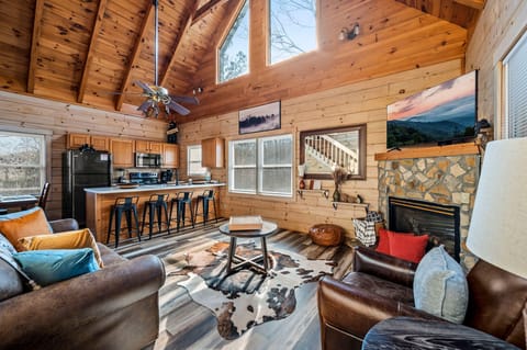 Living room w/ queen sleeper sofa, roku TV, gas fireplace, and board games