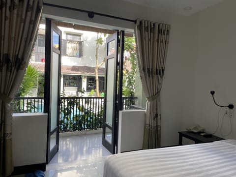 Deluxe Room, Balcony | Minibar, in-room safe, desk, laptop workspace