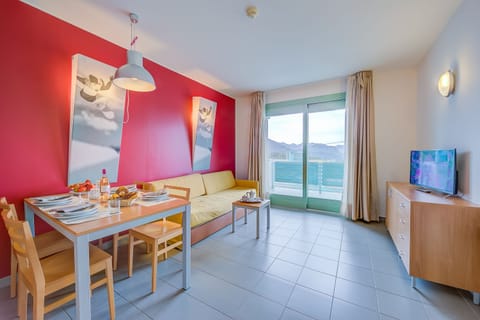 Living area with sofa bed and balcony view