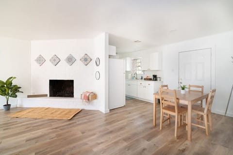 Open-concept dining and living space with fireplace