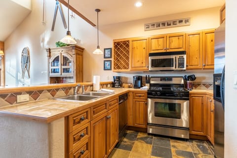 Full size kitchen with stainless steel appliances.