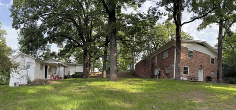 Yard and brick duplex home.  View of the downstairs entrance.