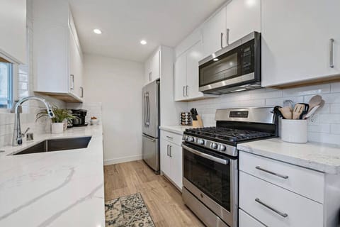 Cook your favorite meal on this well stocked, clean kitchen.