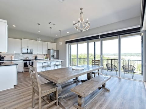- Lakeview dining room with rustic table perfect for group meals - Bright natural light enhances every mealtime memory together - Open design connects kitchen patio and living for relaxing flow