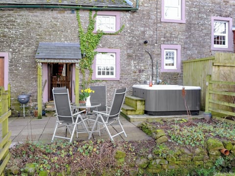 Spacious patio with hot tub and sittng out area | Woodpecker Cottage - Wallace Lane Farm Cottages, Brocklebank, near Caldbeck and Uldale