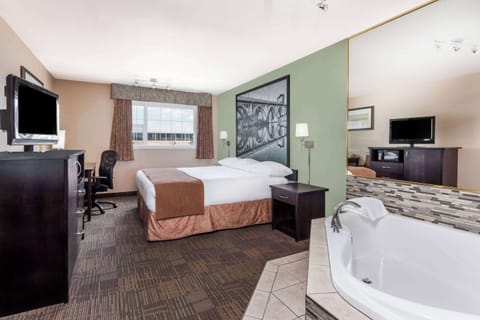 Suite, 1 King Bed, Jetted Tub | Desk, laptop workspace, soundproofing, iron/ironing board