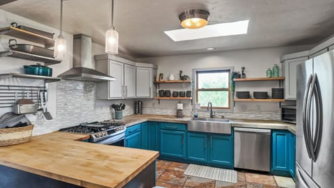 Spacious kitchen layout with vibrant cabinetry and modern touches