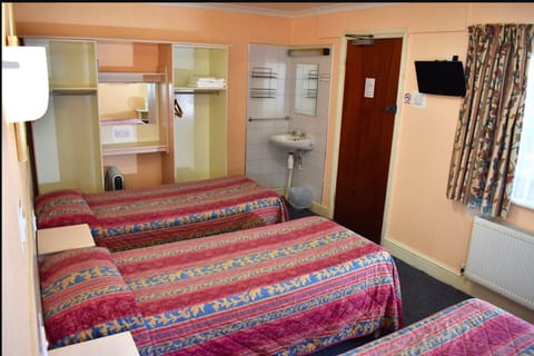 Triple Room, Shared Bathroom | Blackout drapes, iron/ironing board, free WiFi, bed sheets