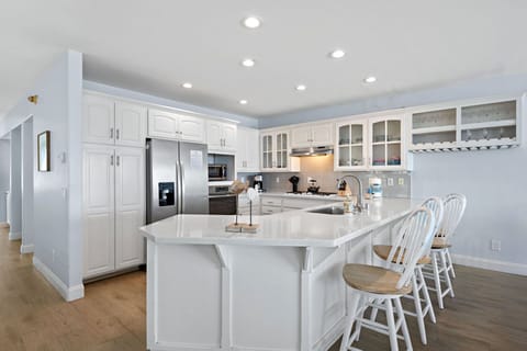 Fully equipped with sleek appliances and a spacious island, this kitchen is designed for cooking, gathering and making memories