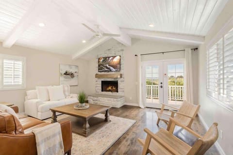 Relax in this cozy living room with a TV and French doors that open up to the balcony.